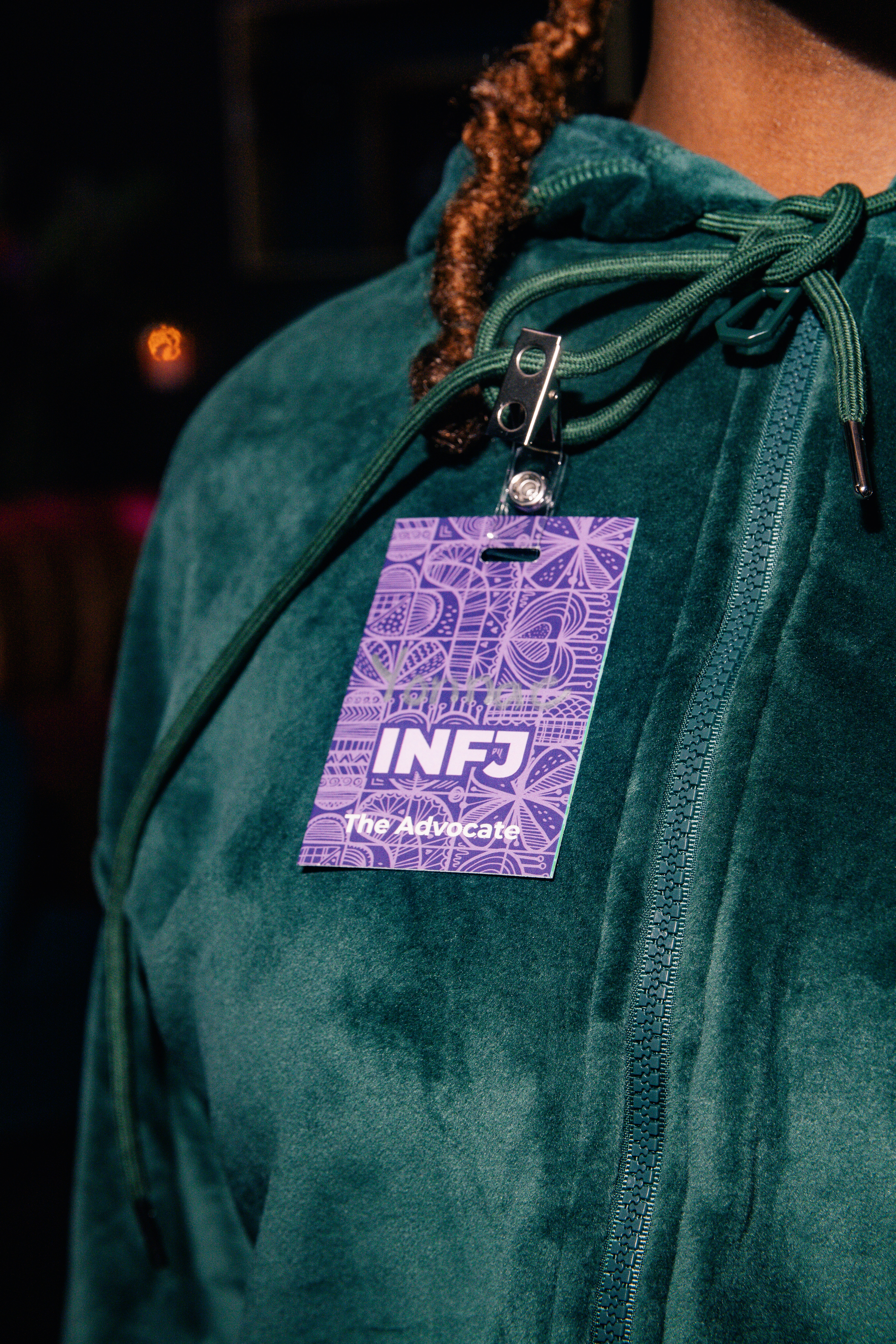 Woman holding her Cuffability nametag at Speed Vibin event