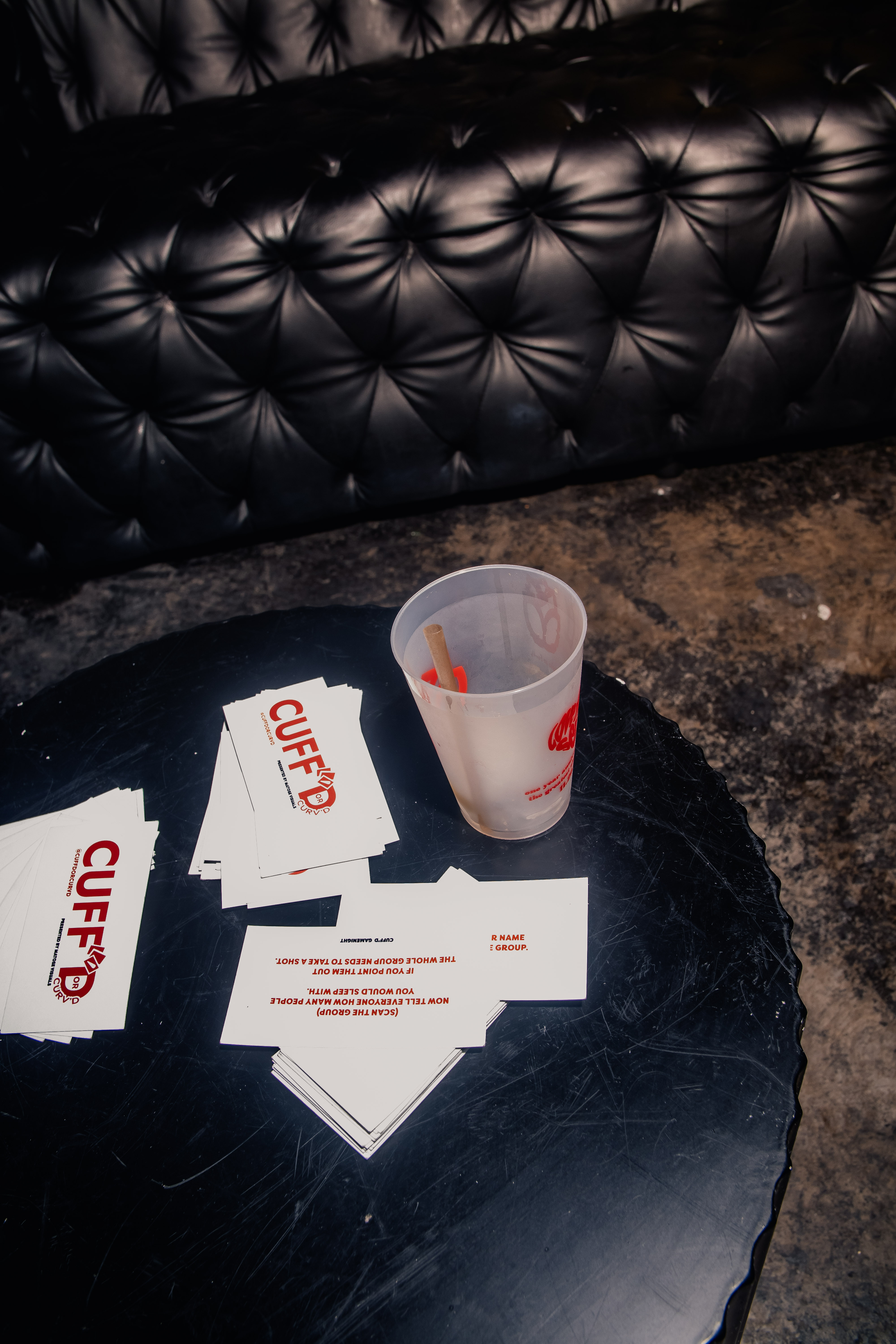 Guests holding up Cuff'd cards at the event